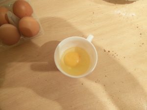 A cracked egg inside the cup