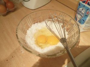 Two eggs in the sugar and vegetable shortening