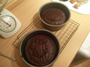 The baked cake pans on a cooling rack