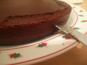 A knife cutting one of the cake halves