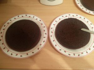 Both halves of a cake half sitting on plates