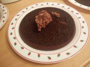 The base layer of the cake with a dollop of the whipping cream mixture