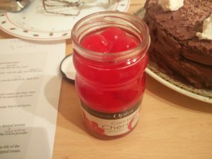The jar of cherries to put onto the cake