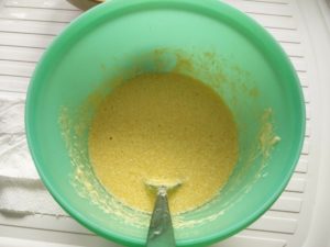 The mix of butter, sugar and eggs in the mixing bowl