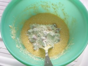 The cherries and flour have been added to the butter, sugar and egg mix