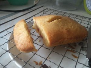 The smaller of the two cakes being cut into slices