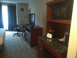 Part of the hotel room showing the TV, fridge and microwave