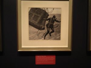 A World War One British photographer jumping from a hot air balloon basket while under attack
