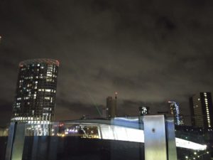 A green laser shining into the night sky