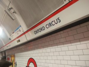 An underground platform sign showing Oxford Circus